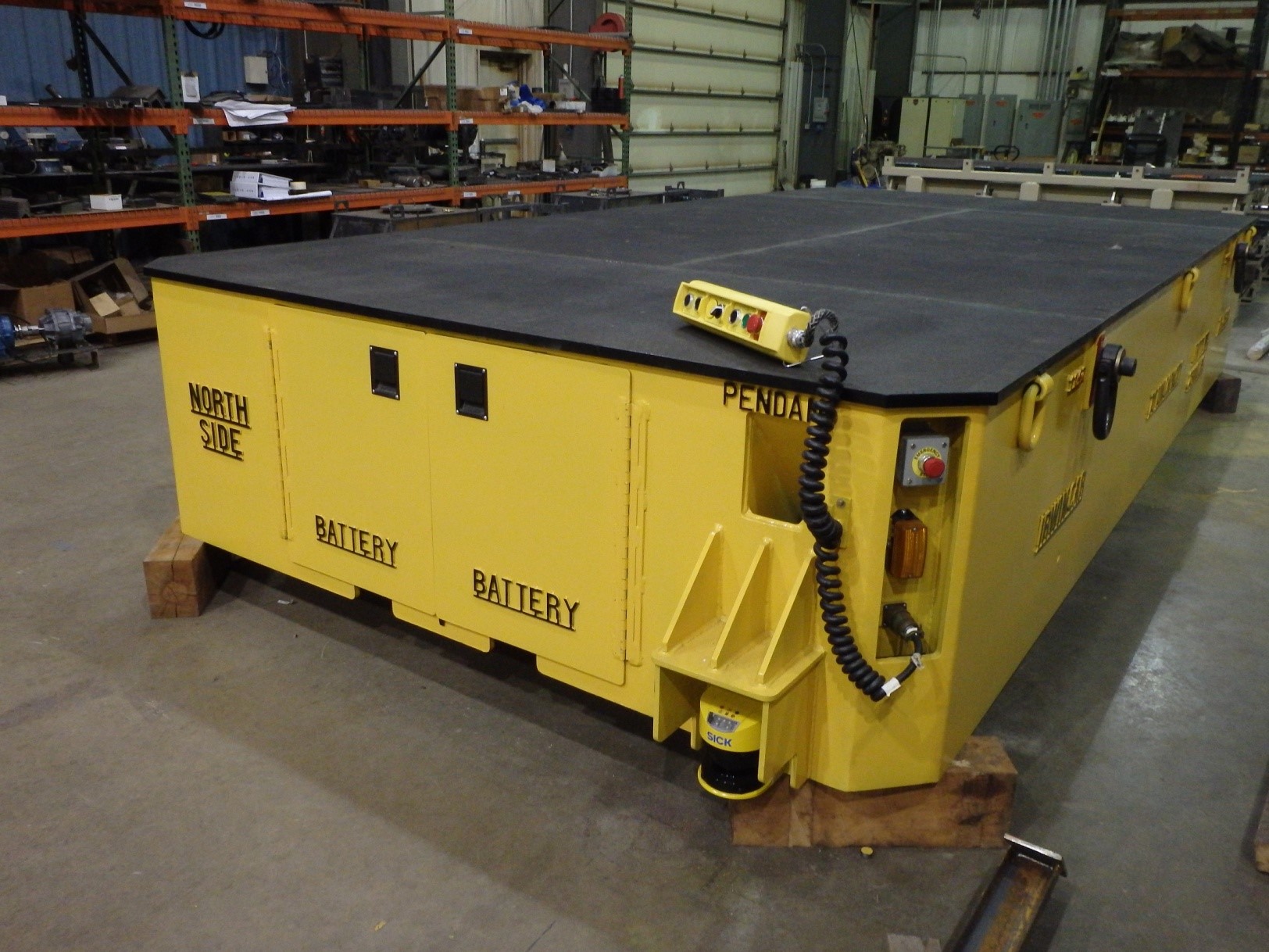 This 70 Ton All Wheel Steer Transporter was designed for loading and unloading automotive stamping dies using an overhead crane. The deck size is 11’ wide x 19’ long and has anti-slip decking and tie down rings to keep the load secure.